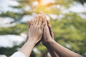 Diverse hands together in the sky